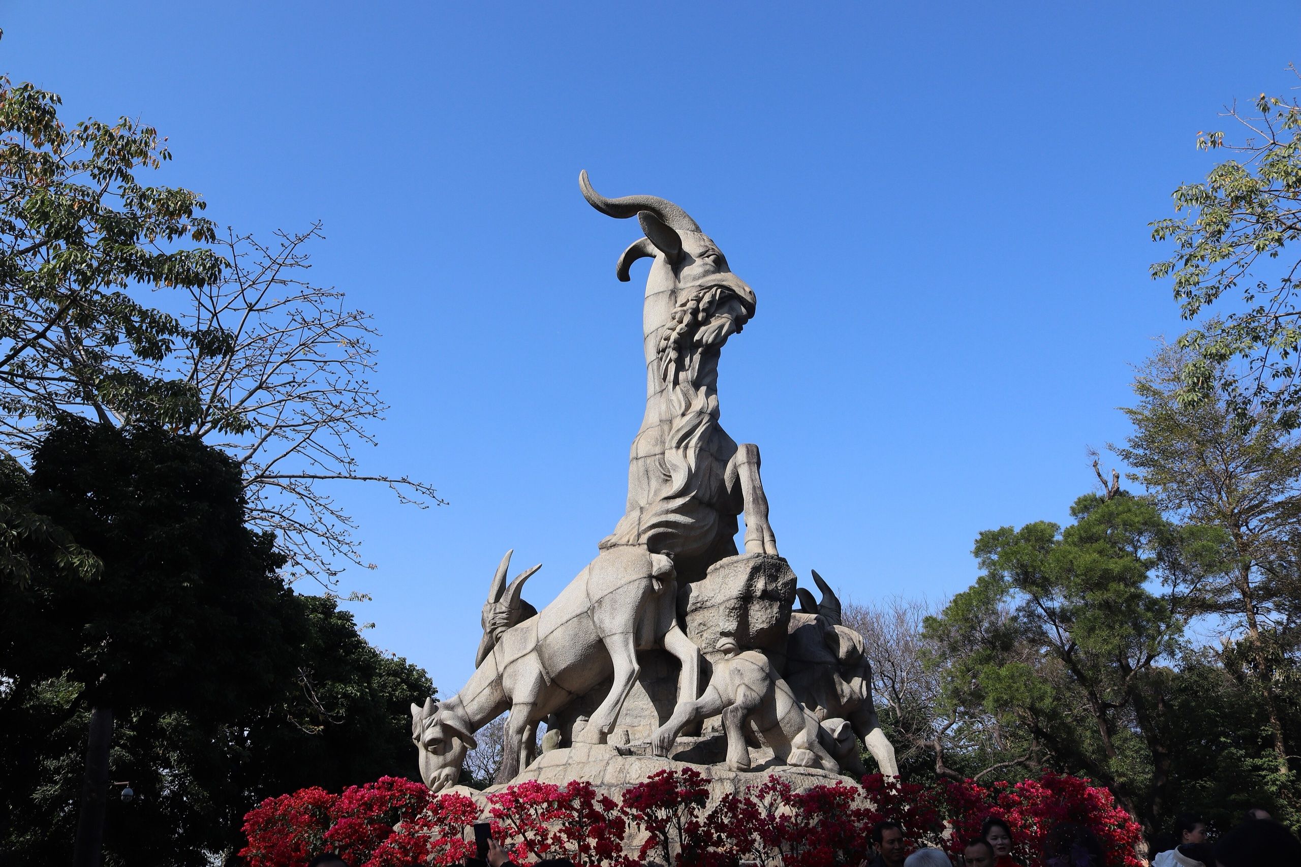 Five Rams statue in Yuexiu Park against a blue sky