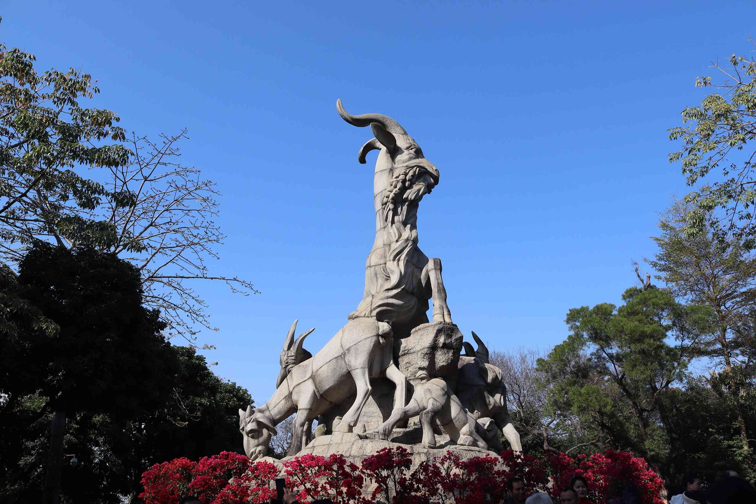 Five Rams statue in Yuexiu Park against a blue sky