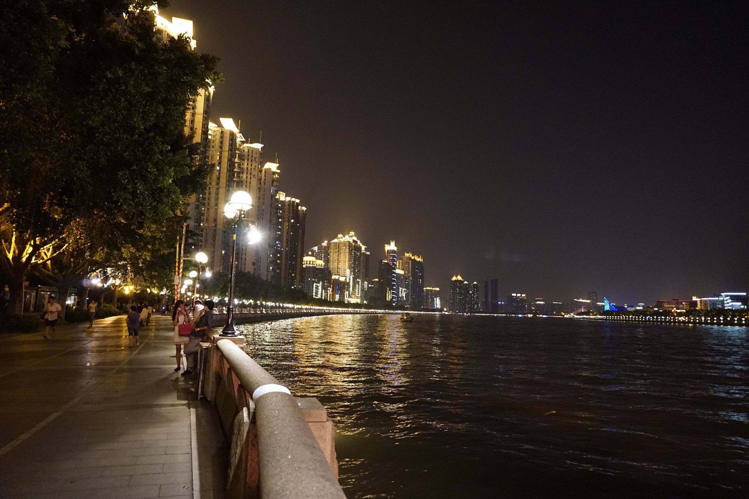 Riverside walkway along the Pearl River at night, with the lit-up skyline