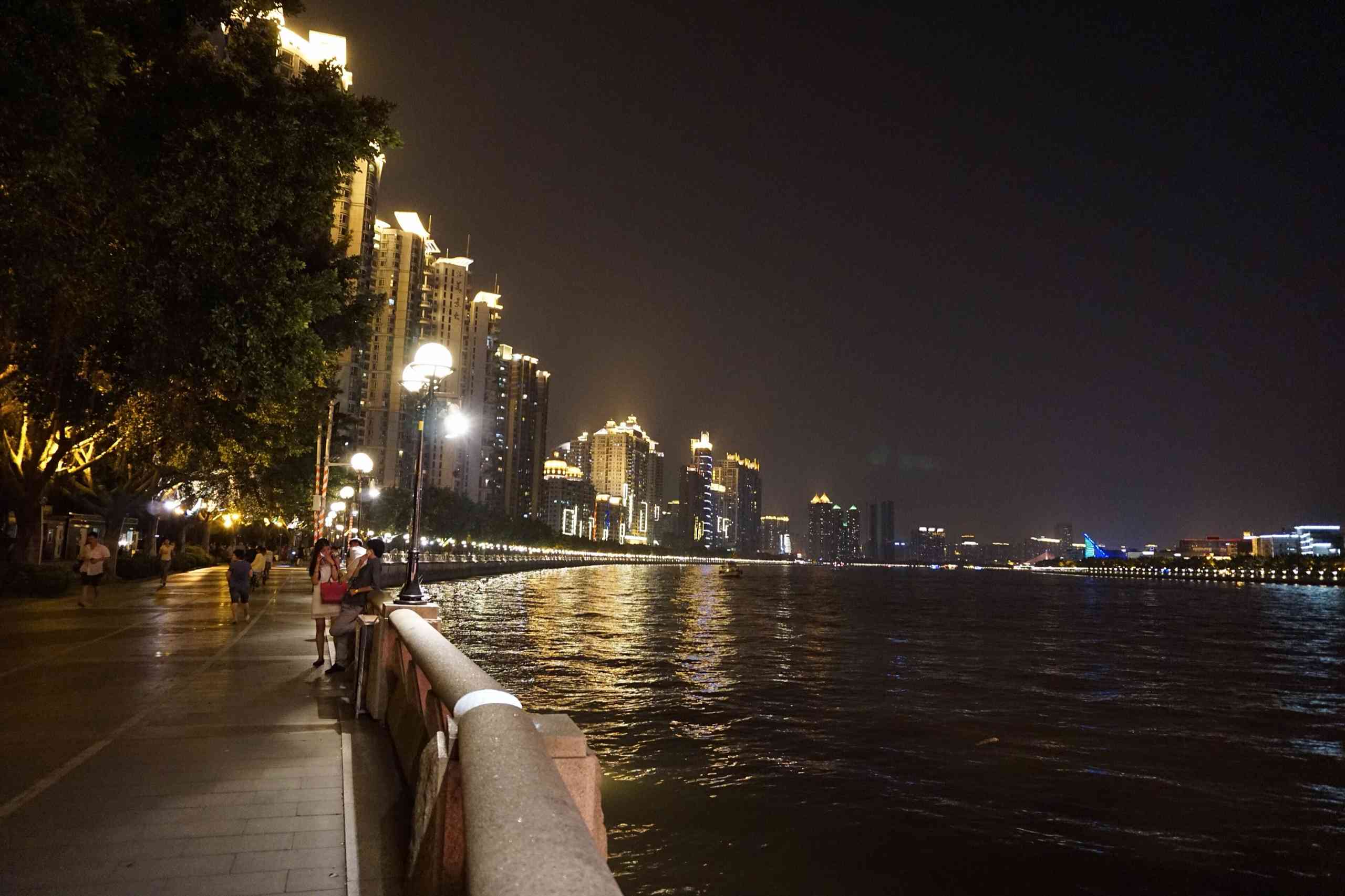 Riverside walkway along the Pearl River at night, with the lit-up skyline