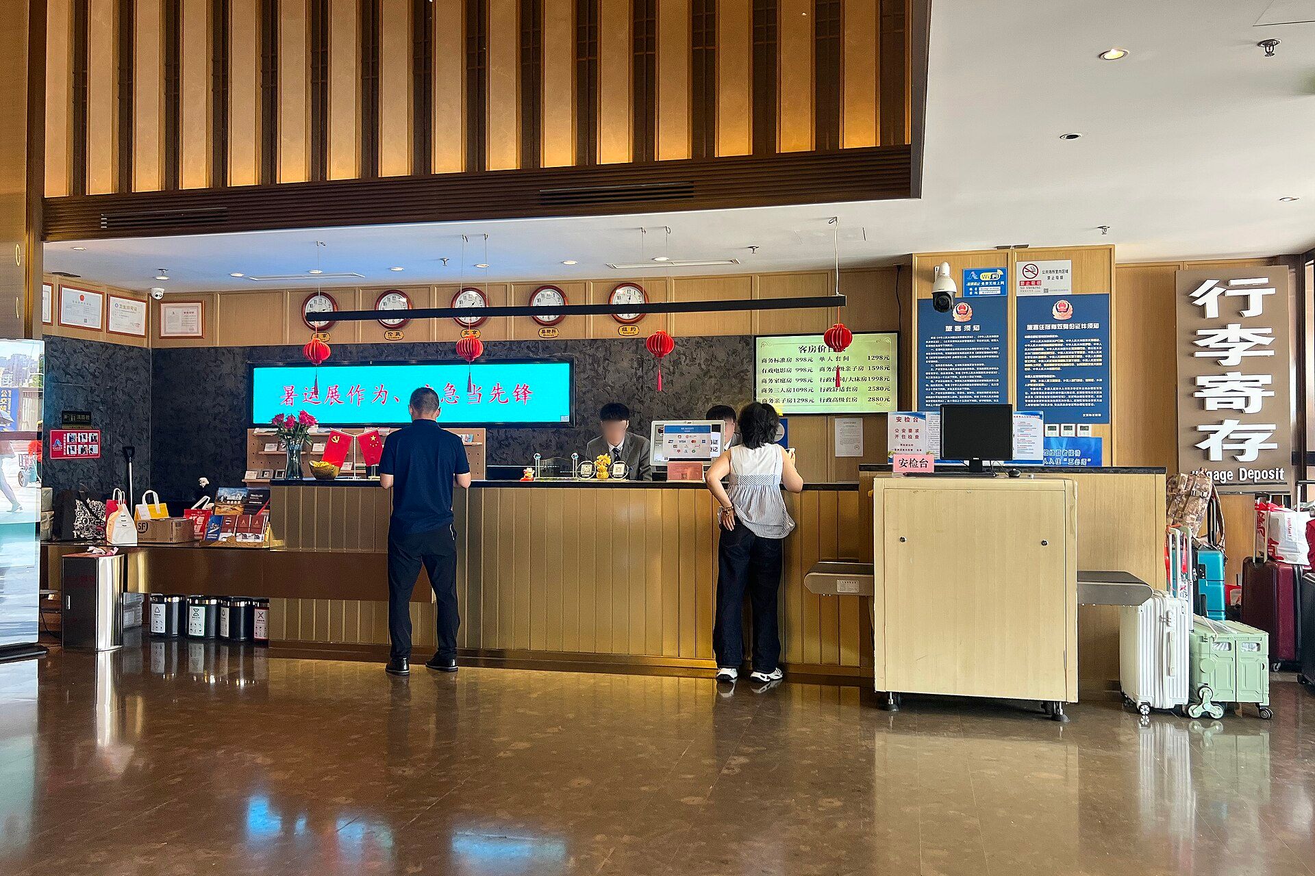 Check-in counter of a hotel in China, with a police notice for guests